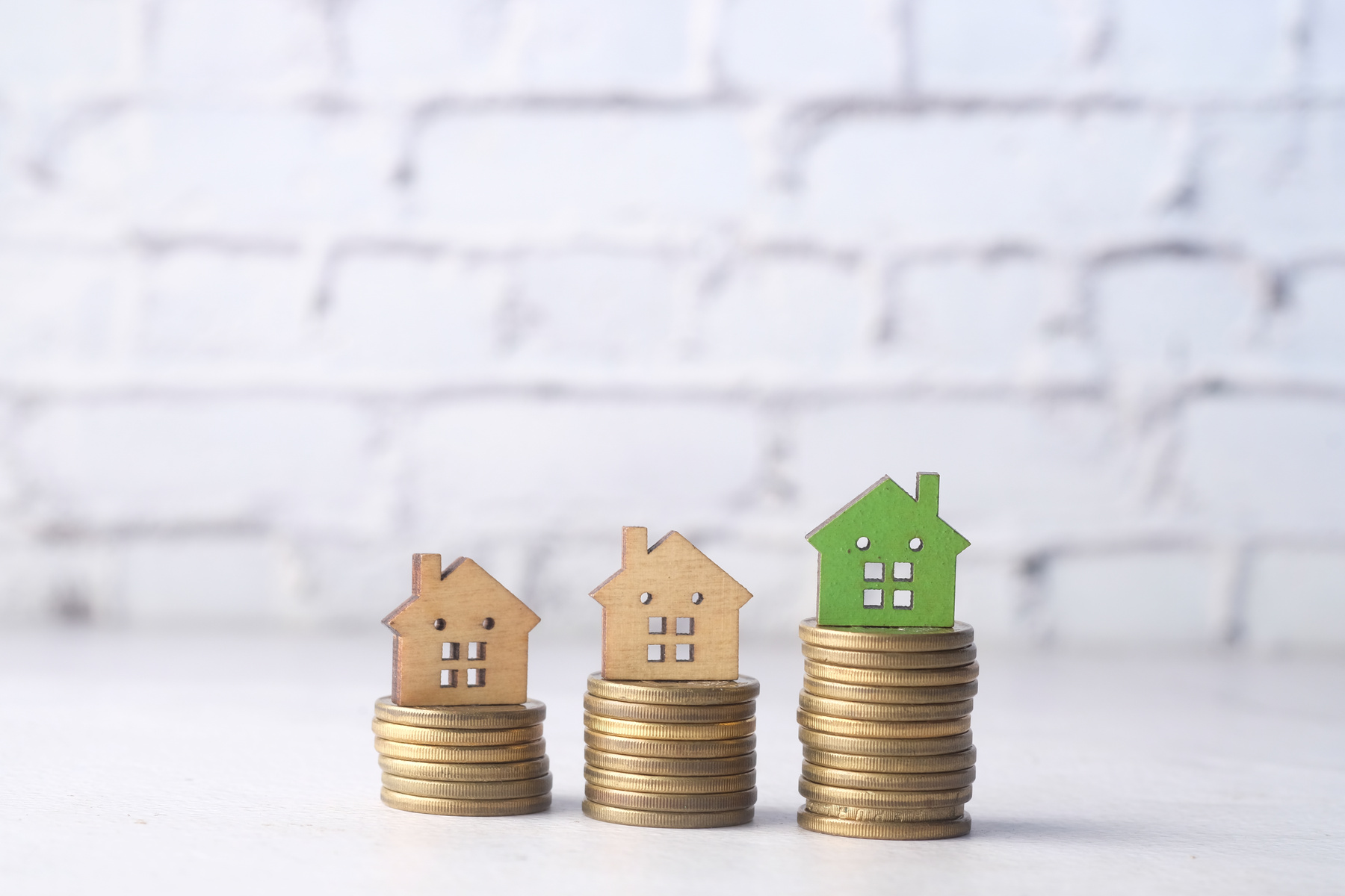 The Concept of Finance Concept with Stack of Coins and House on Table